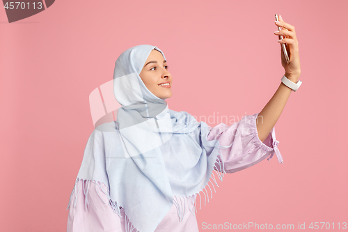 Image of Happy arab woman in hijab. Portrait of smiling girl, posing at studio background
