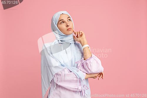 Image of The arab woman in hijab. Portrait of serious girl, posing at studio background