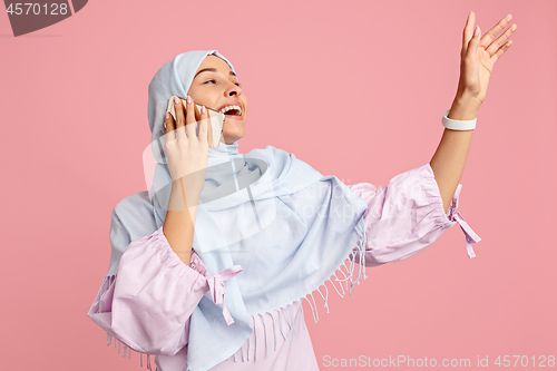 Image of Happy arab woman in hijab. Portrait of smiling girl, posing at studio background