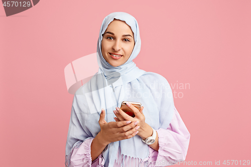 Image of Happy arab woman in hijab. Portrait of smiling girl, posing at studio background