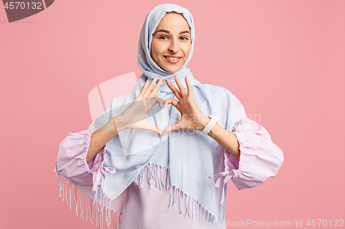 Image of Happy arab woman in hijab. Portrait of smiling girl, posing at studio background