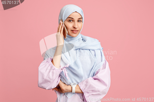 Image of Happy arab woman in hijab. Portrait of smiling girl, posing at studio background