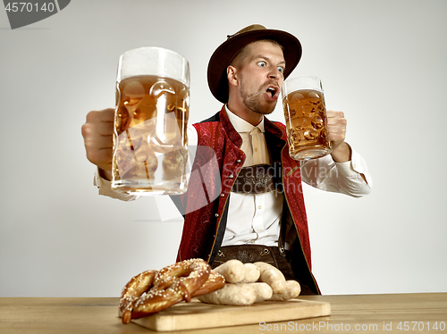Image of Germany, Bavaria, Upper Bavaria, man with beer dressed in traditional Austrian or Bavarian costume