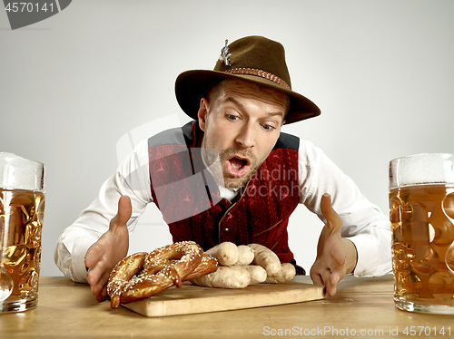 Image of Germany, Bavaria, Upper Bavaria, man with beer dressed in traditional Austrian or Bavarian costume