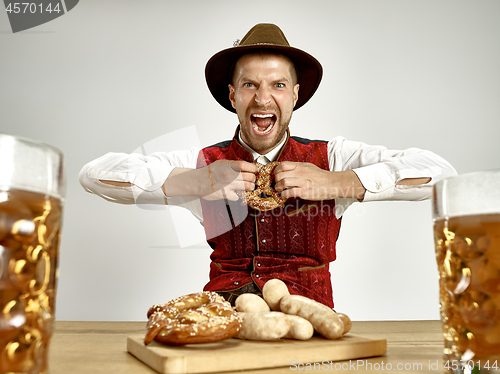 Image of Germany, Bavaria, Upper Bavaria, man with beer dressed in traditional Austrian or Bavarian costume