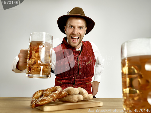 Image of Germany, Bavaria, Upper Bavaria, man with beer dressed in traditional Austrian or Bavarian costume