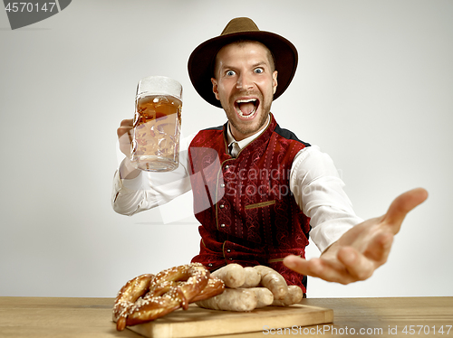 Image of Germany, Bavaria, Upper Bavaria, man with beer dressed in traditional Austrian or Bavarian costume