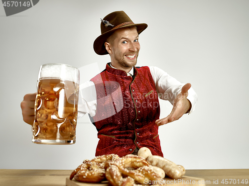 Image of Germany, Bavaria, Upper Bavaria, man with beer dressed in traditional Austrian or Bavarian costume