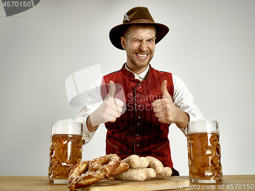 Image of Germany, Bavaria, Upper Bavaria, man with beer dressed in traditional Austrian or Bavarian costume