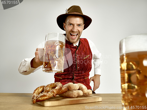 Image of Germany, Bavaria, Upper Bavaria, man with beer dressed in traditional Austrian or Bavarian costume