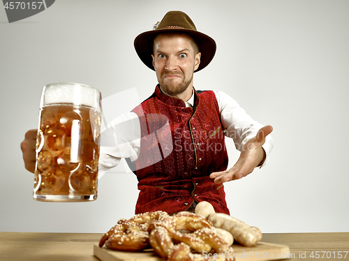 Image of Germany, Bavaria, Upper Bavaria, man with beer dressed in traditional Austrian or Bavarian costume