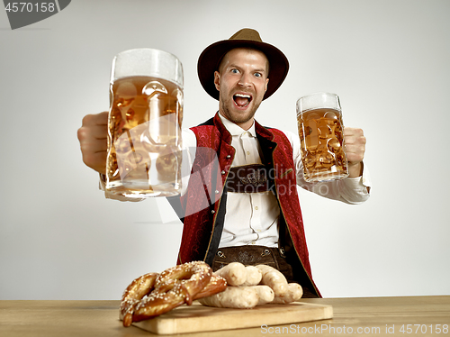 Image of Germany, Bavaria, Upper Bavaria, man with beer dressed in traditional Austrian or Bavarian costume