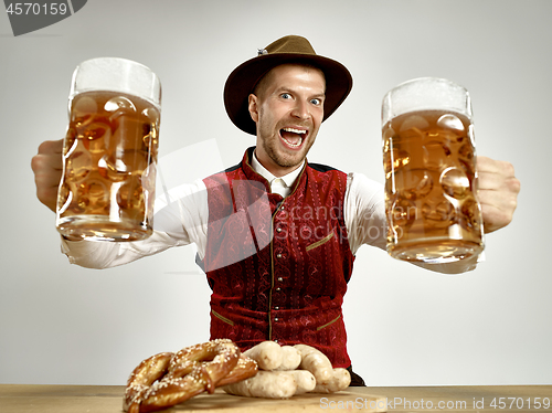 Image of Germany, Bavaria, Upper Bavaria, man with beer dressed in traditional Austrian or Bavarian costume