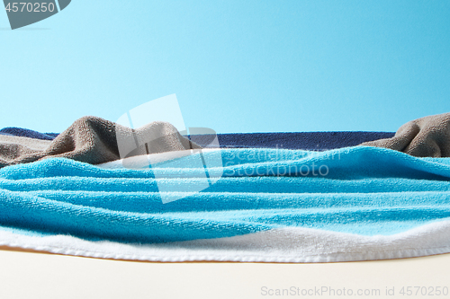 Image of Coastline with waves and stones made from towels on a paper background