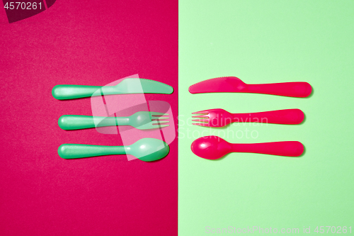 Image of Colorful pattern from plastic eating utensil on a duotone background.