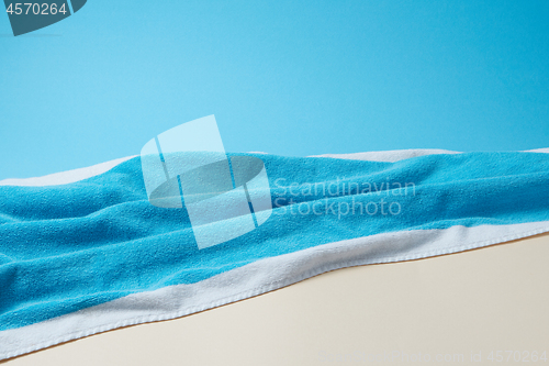 Image of Summer background with blue towel on duotone paper.