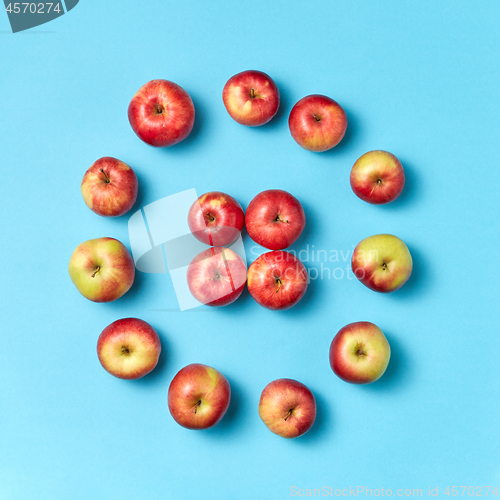 Image of Round apples frame on a blue background.