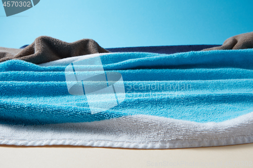 Image of Handmade waves of blue sea made from beach terry towels.