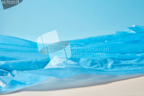 Image of Blue plastic garbage bag as a seascape background.