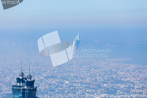 Image of Skyline of Dubai beachfront with Burj Al Arab hotel on Jumeirah beach seen from Burj Khalifa viewpoint.