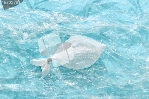 Image of Fish made from plastic bag on a transparent polyethylene background.