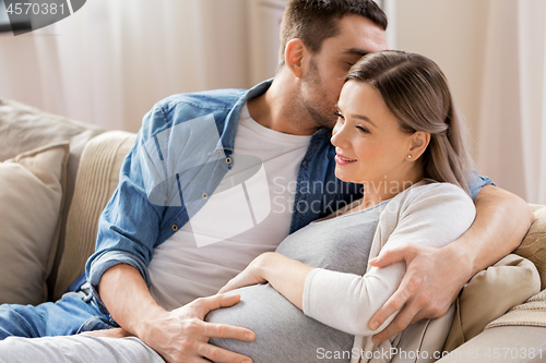 Image of man hugging pregnant woman at home