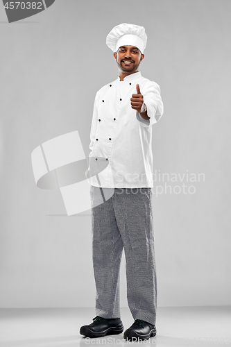 Image of happy male indian chef in toque showing thumbs up