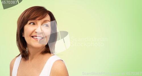 Image of portrait of smiling senior woman over white