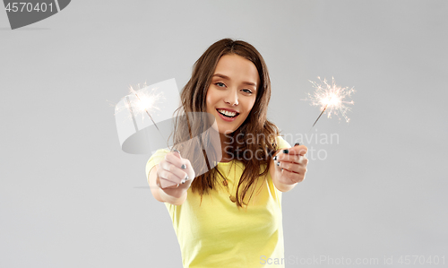 Image of shocked indian man over grey background