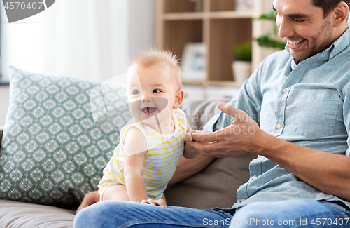 Image of father with little baby daughter at home