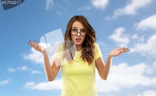 Image of confused woman or teenage girl in glasses