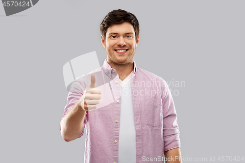 Image of happy young man showing thumbs up