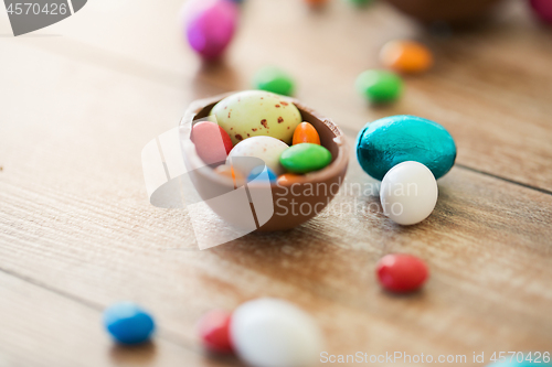 Image of chocolate easter egg and candy drops on table