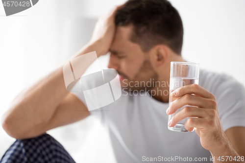 Image of close up of sick man with glass of water