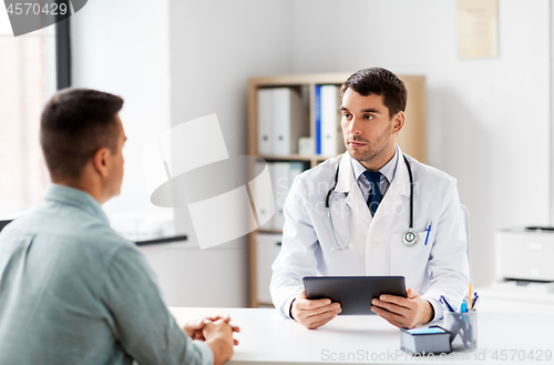 Image of doctor with tablet computer and patient at clinic