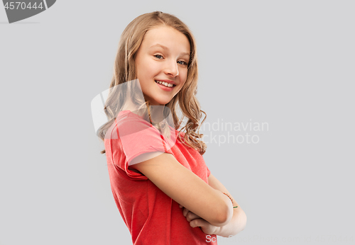 Image of smiling teenage girl in red t-shirt over grey