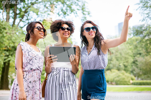 Image of women with tablet computer on street in summer