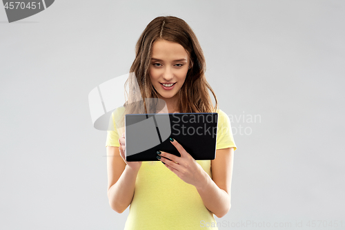 Image of young woman or teenage girl using tablet computer