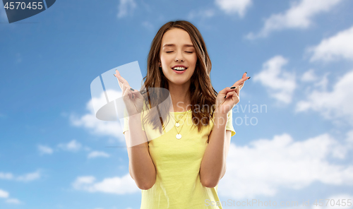 Image of young woman or teenage girl with fingers crossed