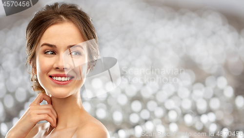 Image of smiling young woman over grey background