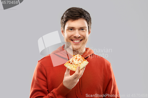 Image of happy young man eating pizza