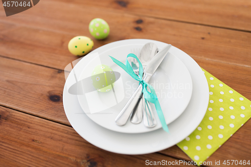 Image of easter egg in cup holder, plates and cutlery