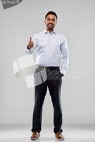 Image of smiling indian businessman showing thumbs up