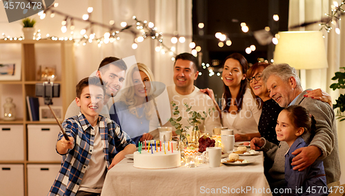 Image of family having birthday party and taking selfie