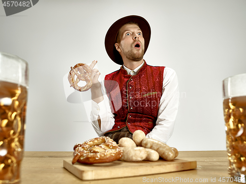 Image of Germany, Bavaria, Upper Bavaria, man with beer dressed in traditional Austrian or Bavarian costume