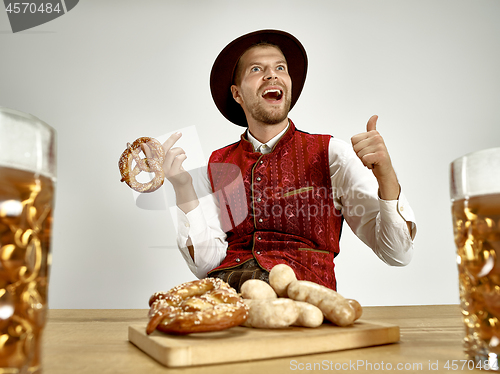 Image of Germany, Bavaria, Upper Bavaria, man with beer dressed in traditional Austrian or Bavarian costume