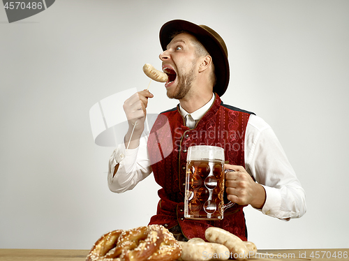 Image of Germany, Bavaria, Upper Bavaria, man with beer dressed in traditional Austrian or Bavarian costume