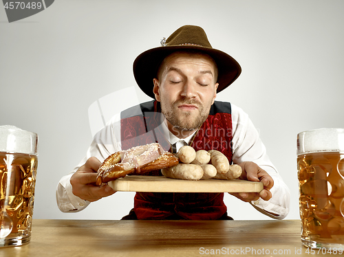 Image of Germany, Bavaria, Upper Bavaria, man with beer dressed in traditional Austrian or Bavarian costume