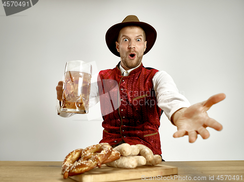 Image of Germany, Bavaria, Upper Bavaria, man with beer dressed in traditional Austrian or Bavarian costume