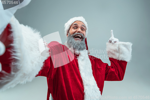 Image of Funny guy in christmas hat. New Year Holiday. Christmas, x-mas, winter, gifts concept.